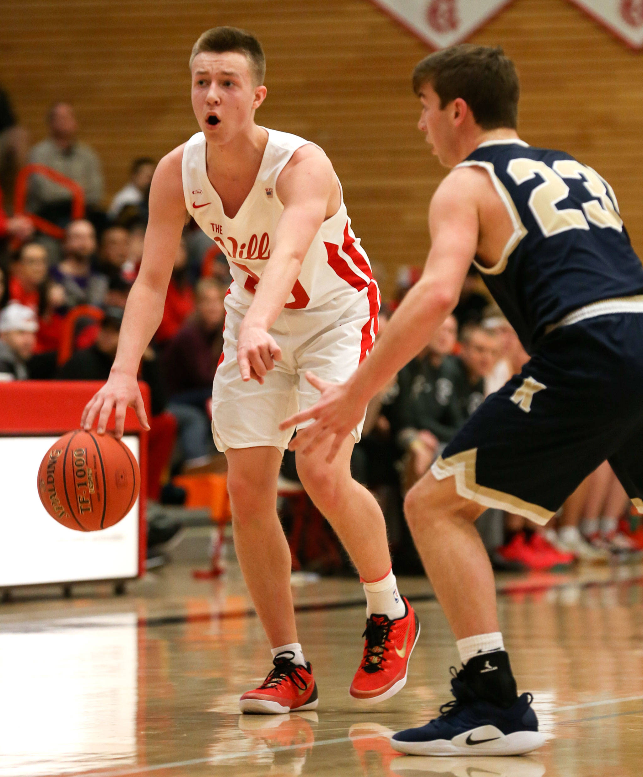 Marysville Pilchuck’s Luke Dobler directs traffic on the floor as Kelso’s Wyatt Brown defends during a 3A state regional game on Feb. 22 at the Walt Price Student Fitness Center on the campus of Everett Community College. (Kevin Clark / The Herald)