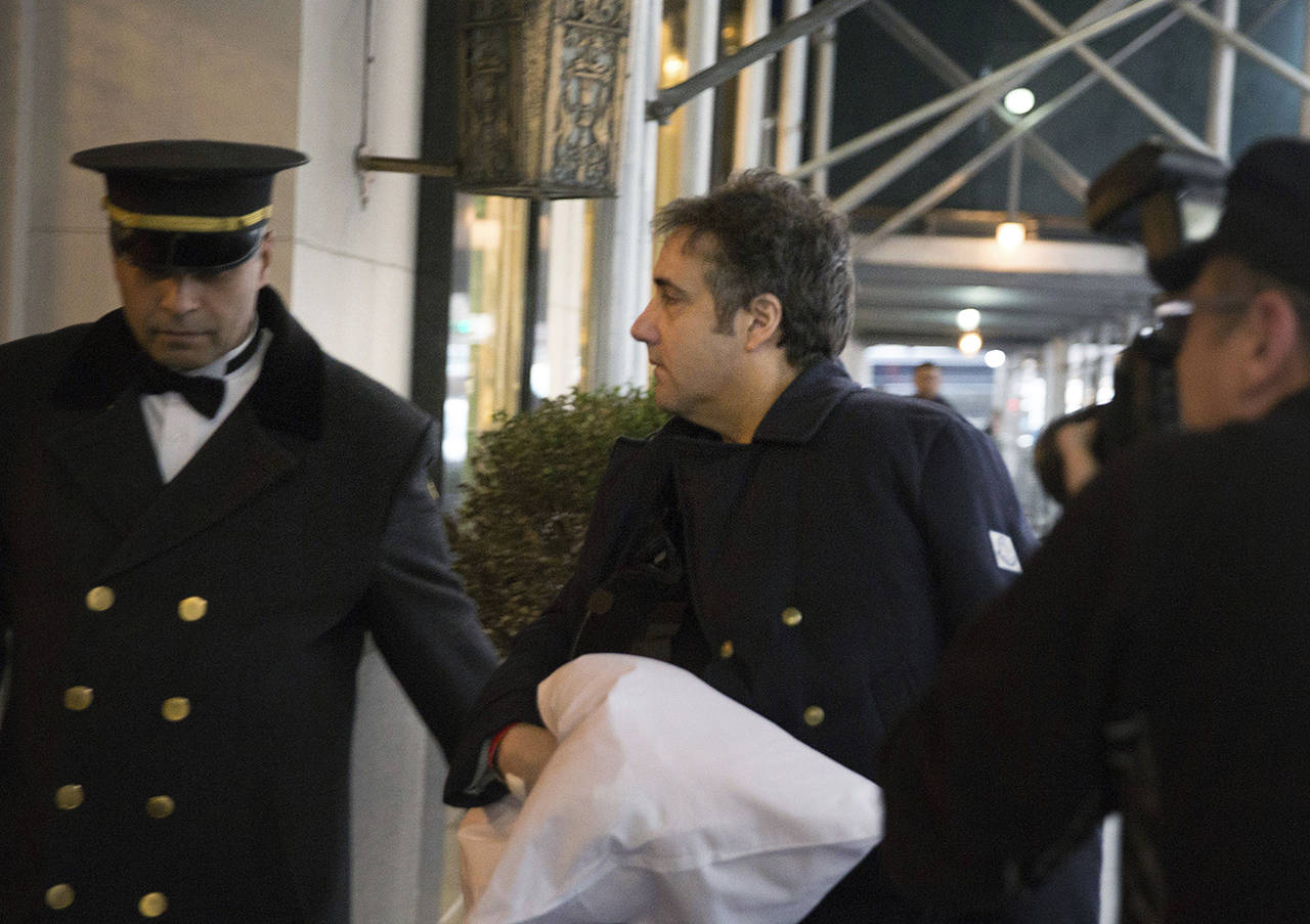Michael Cohen arrives at his home in New York with his left arm in a sling and supported by a pillow on Jan. 18 after medical treatment. (AP Photo/Kevin Hagen)