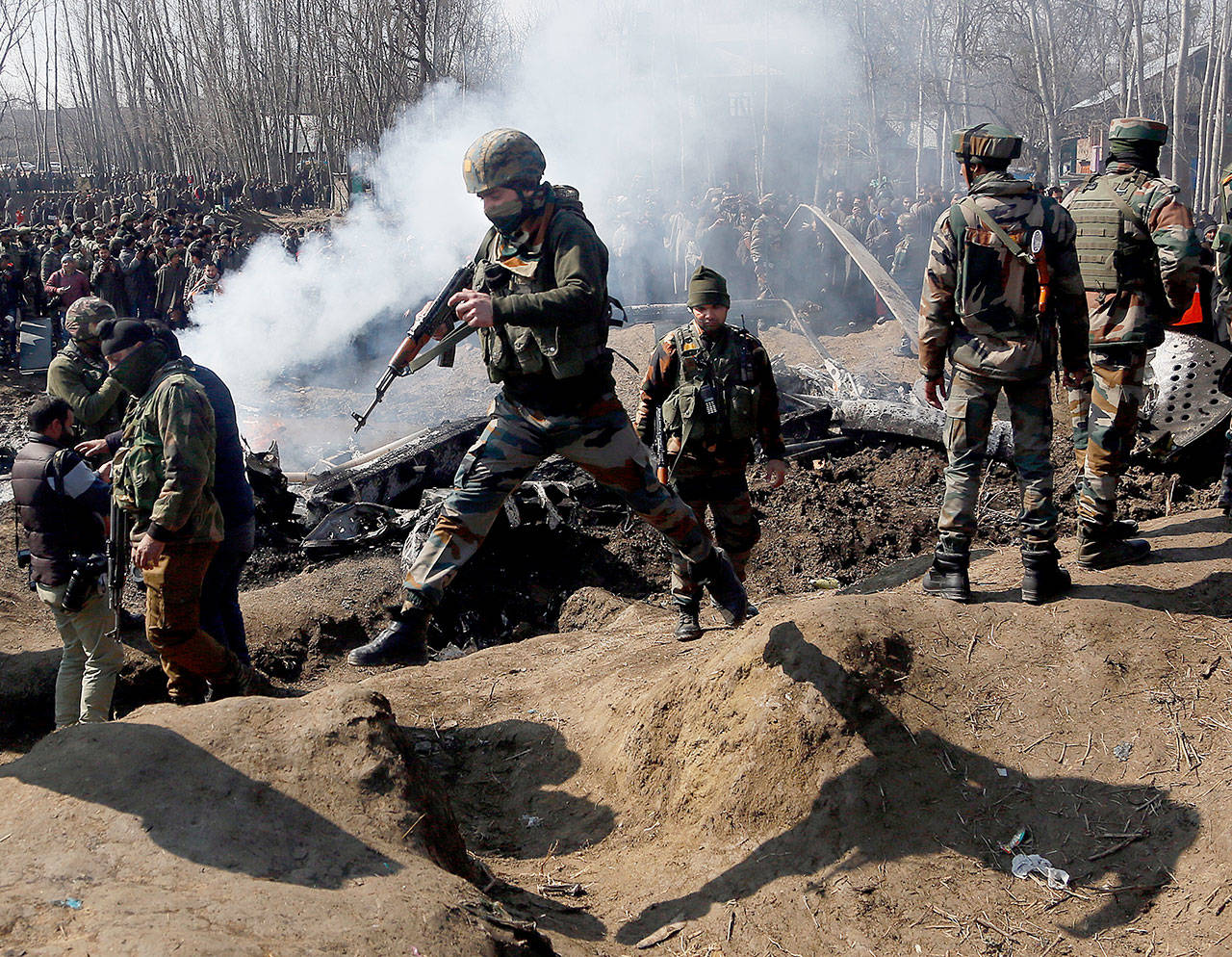 Indian army soldiers arrive near the wreckage of an Indian aircraft after it crashed in the Budgam area, outside Srinagar in Indian-controlled Kashmir on Wednesday. (AP Photo/Mukhtar Khan)