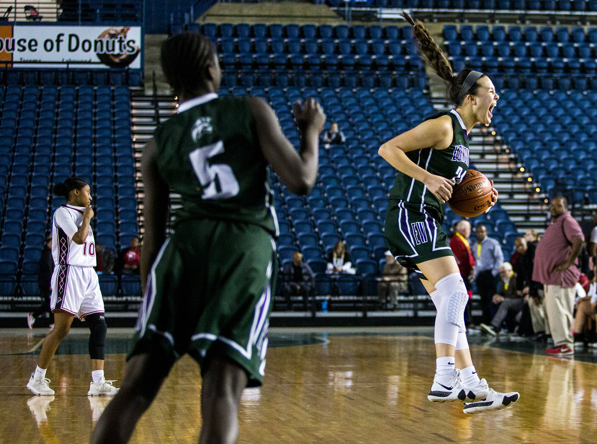 Edmonds-Woodway’s Rebekah Dasalla jumps and screams after the final buzzer as Bethel’s Nakima Miller walks off the court after the game against Bethel at the 3A Girls Hardwood Classic on Wednesday, Feb. 27, 2019 in Tacoma, Wash. (Olivia Vanni / The Herald)