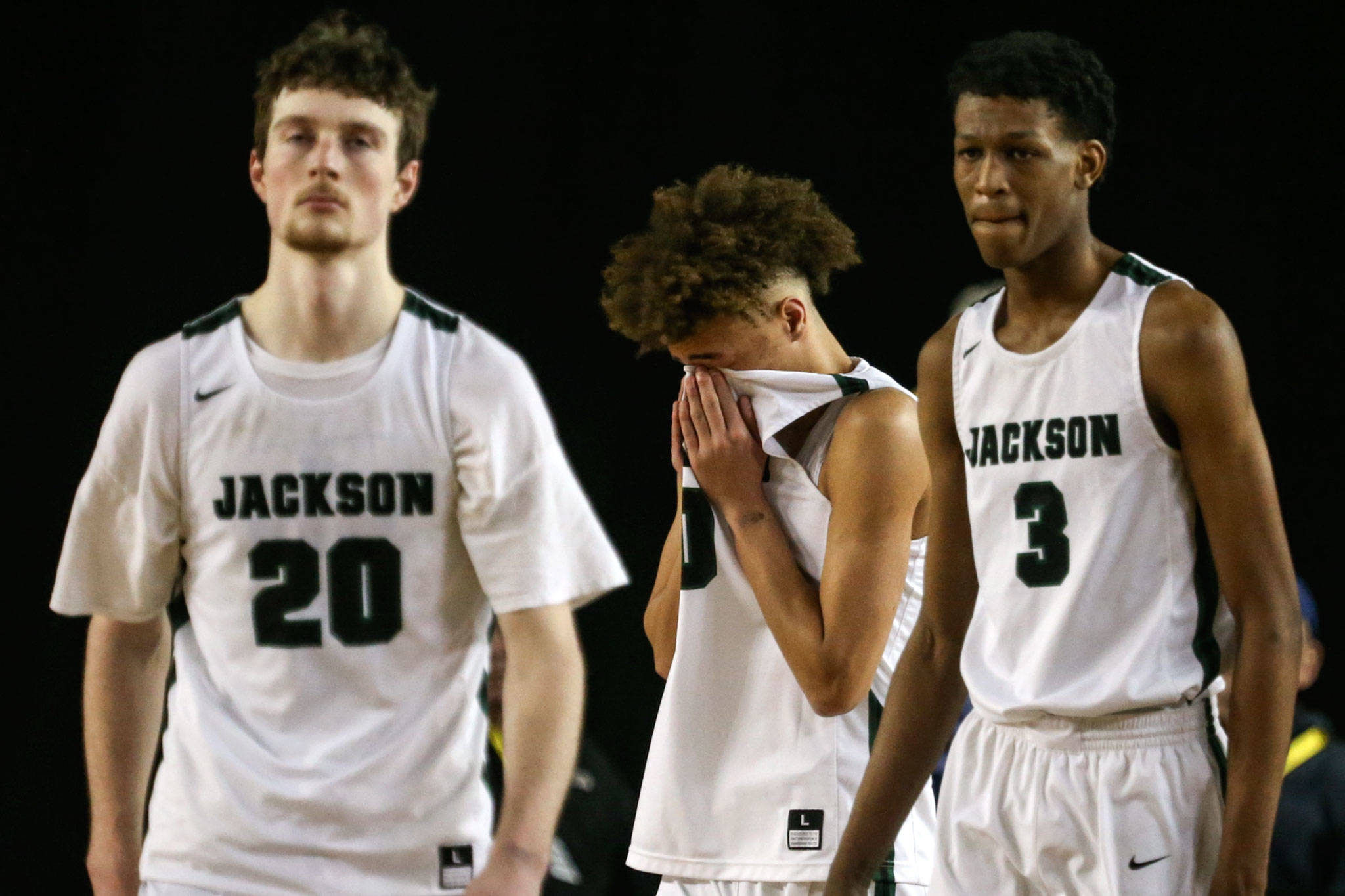 Jackson’s Kyle Bigovich (left-right) Christian Liddell and Jaylen Searles leave to court dejected after loosing to Puyallup Wednesday morning at the Tacoma Dome on February 27, 2019. The Timberwolves lost 56-50. (Kevin Clark / The Herald)