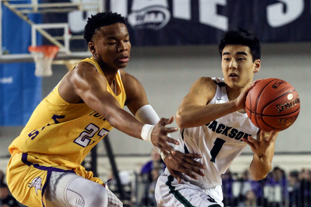 Jackson’s Kevin Han looks to pass with Puyallup’s Kendell Munson defending Wednesday morning at the Tacoma Dome on February 27, 2019. The Timberwolves lost 56-50.(Kevin Clark / The Herald)
