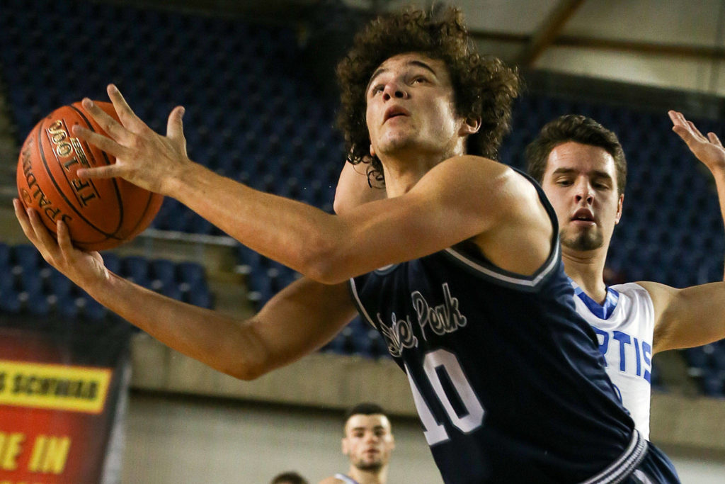 Glacier Peak’s Brayden Quantrille attempts a shot with Curtis’ Dylan Yager Wednesday afternoon at the Tacoma Dome on February 27, 2019. The Grizzles lost 46-43. (Kevin Clark / The Herald)
