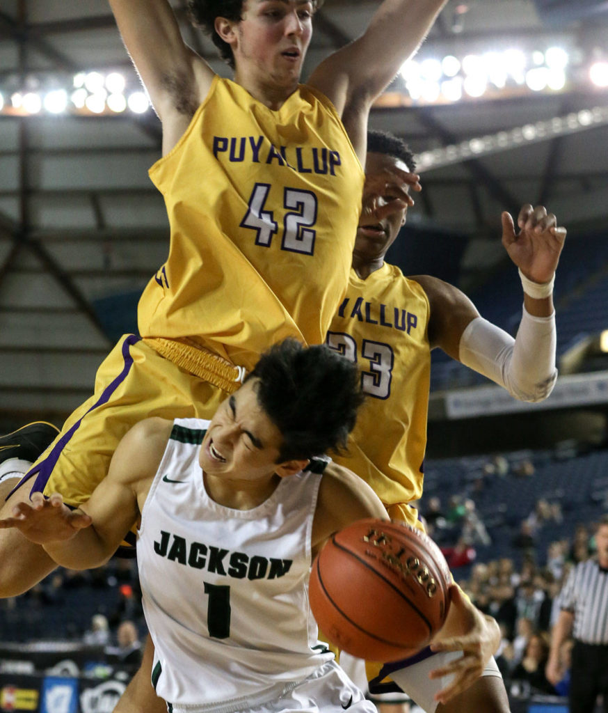 Jackson’s Kevin Han is fouled by Puyallup’s Dylan Rhodes Wednesday morning at the Tacoma Dome on February 27, 2019. The Timberwolves lost 56-50. (Kevin Clark / The Herald)
