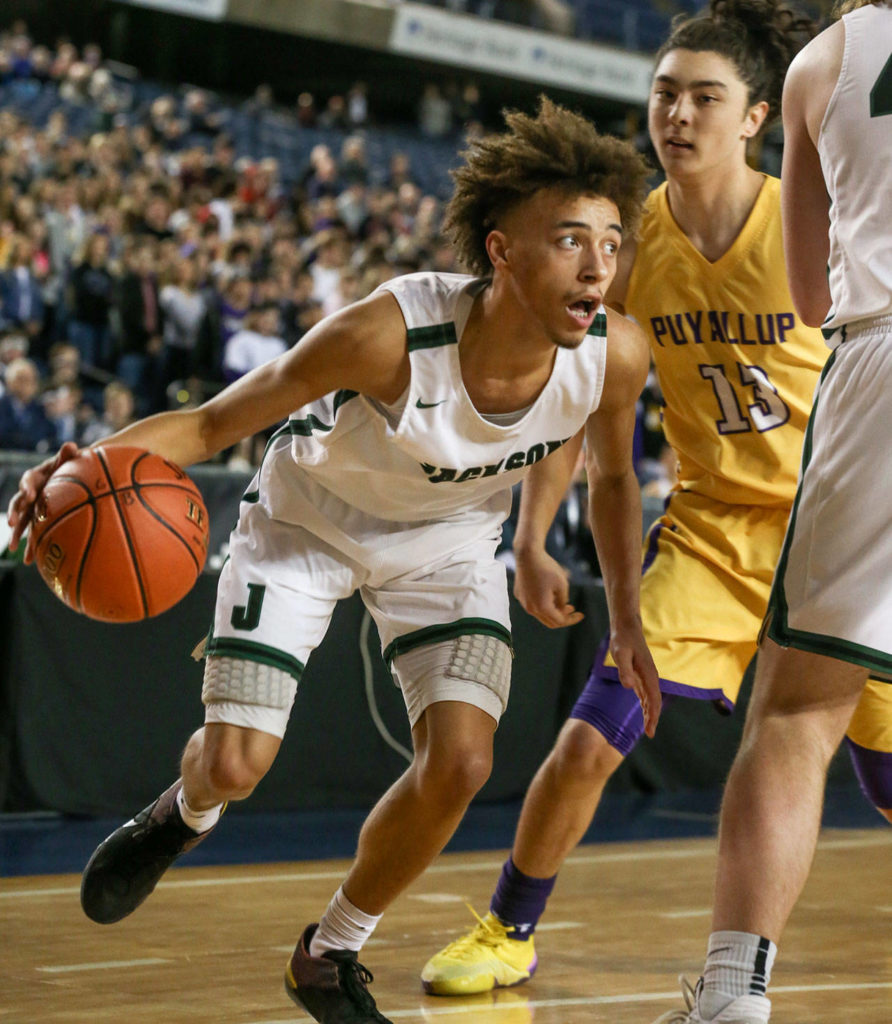 Jackson’s Christian Liddell drives the baseline with Puyallup’s Luke Holcomb (right) looking on Wednesday morning at the Tacoma Dome on February 27, 2019. The Timberwolves lost 56-50. (Kevin Clark / The Herald)
