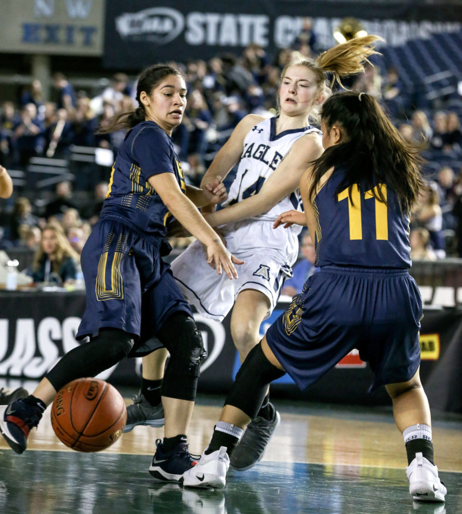 Arlington’s Keira Marsh attempts a pass through West Seattle’s defense Wednesday afternoon at the Tacoma Dome on February 27, 2019. The Eagles lost 50-45. (Kevin Clark / The Herald)

