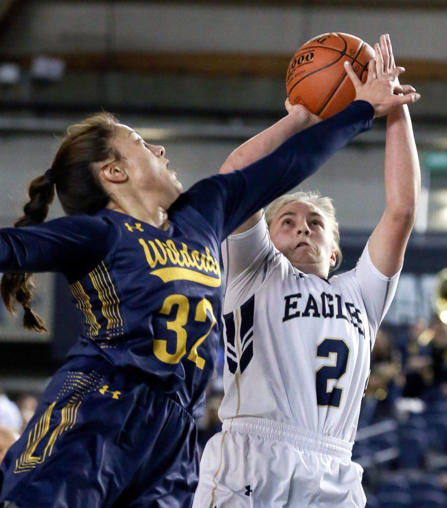 Arlington’s Hailey Hiatt attempts a shot over West Seattle’s Anissa Babitu Wednesday afternoon at the Tacoma Dome on February 27, 2019. The Eagles lost 50-45. (Kevin Clark / The Herald)
