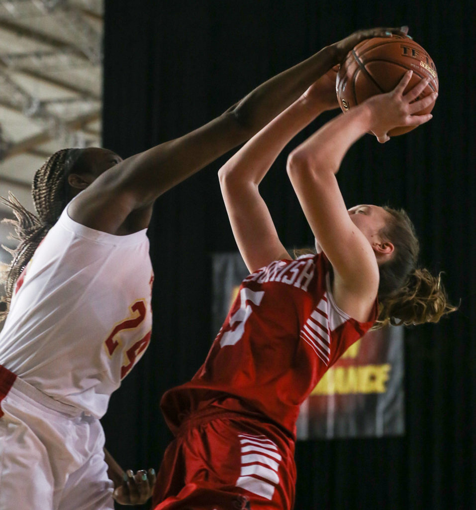 Kamiakin’s Oumou Toure blocks Snohomish’s Ella Gallatin Thursday morning at the Tacoma Dome on February 28, 2019. The Panthers lost 57-39.(Kevin Clark / The Herald)
