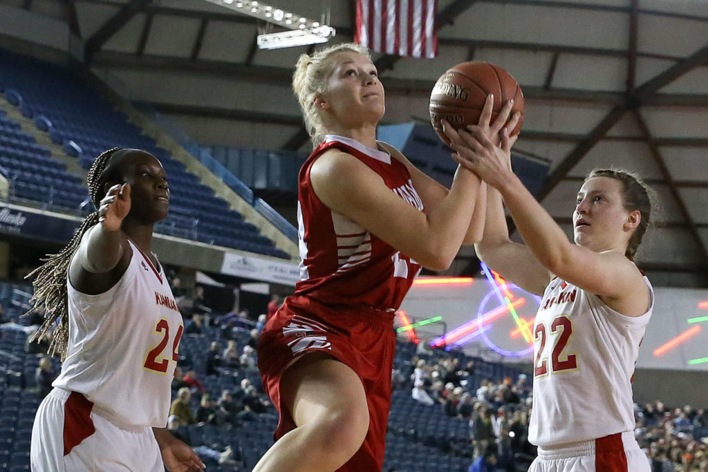 Snohomish’s Kaylin Beckman is tied up with Kamiakin’s Alexa Hazel (right) with Oumou Toure (left) looking on Thursday morning at the Tacoma Dome on February 28, 2019. The Panthers lost 57-39.(Kevin Clark / The Herald)
