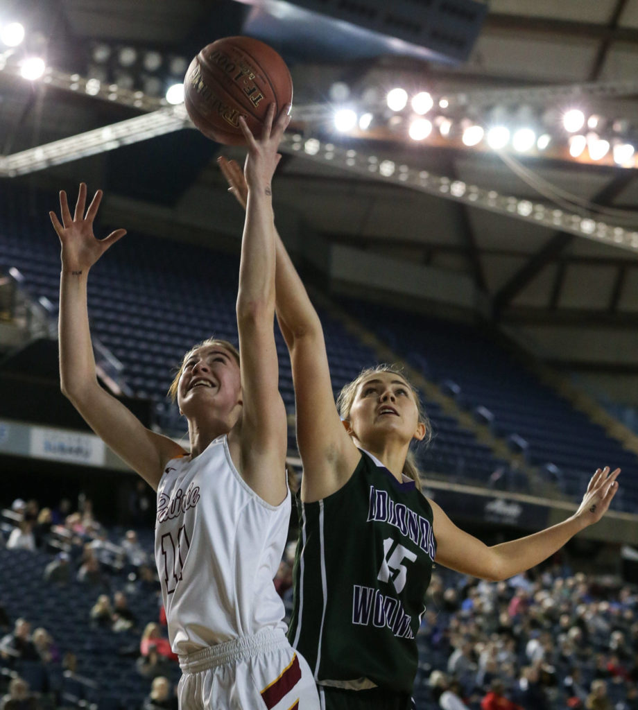 Prairie’s Kendyl Carson and Edmonds-Woodway’s Kristen Reijonen jump for a rebound Thursday morning at the Tacoma Dome on February 28, 2019. The Warriors lost 58-39.(Kevin Clark / The Herald)
