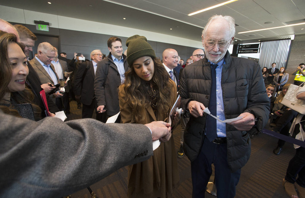 Samantha DeLeon, left, and Joe Clark get their seating arrangements sorted out before boarding the first passenger flight out of Paine Field. (Andy Bronson / The Herald)
