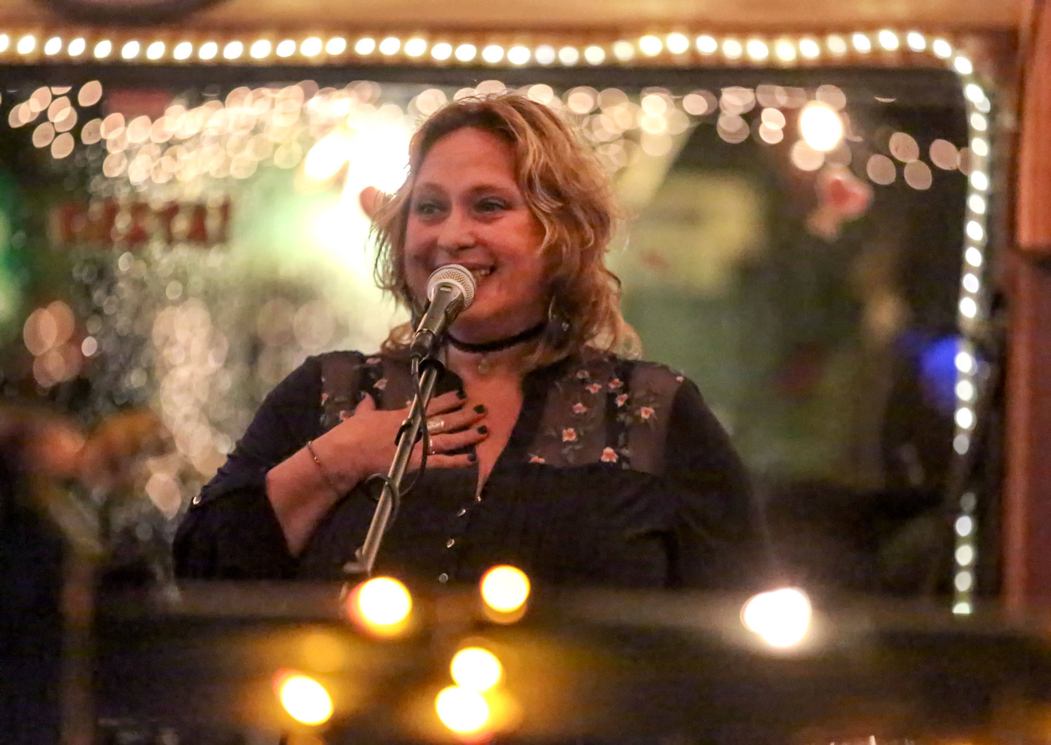 Renata Lubinsky performs stand-up during open mic night at Ould Triangle in Seattle. (Kevin Clark / The Herald)