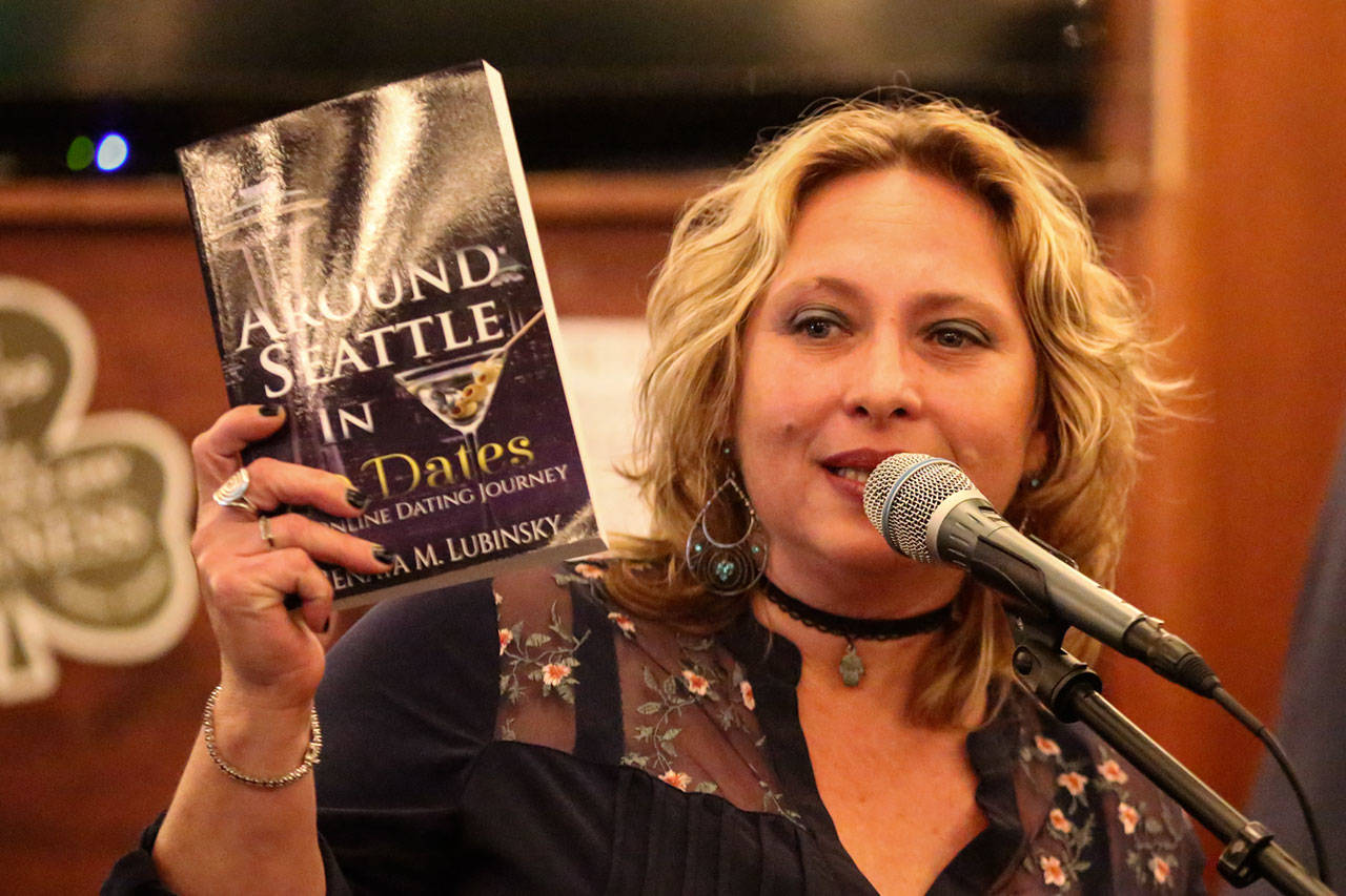 Renata Lubinsky holds a copy of her new book, “Around Seattle in 80 Dates.” (Kevin Clark / The Herald)