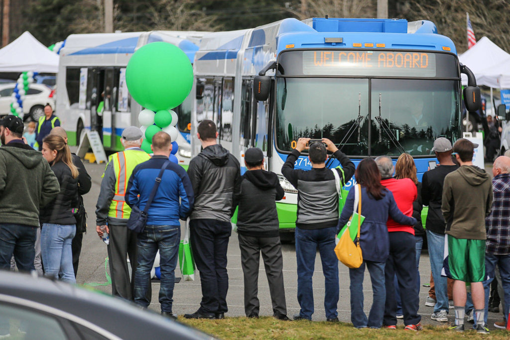 A bus makes its inaugural start of the Swift Green Line route Sunday during the kick-off celebration Sunday morning at McCollum Park in Everett. (Kevin Clark / The Herald)
