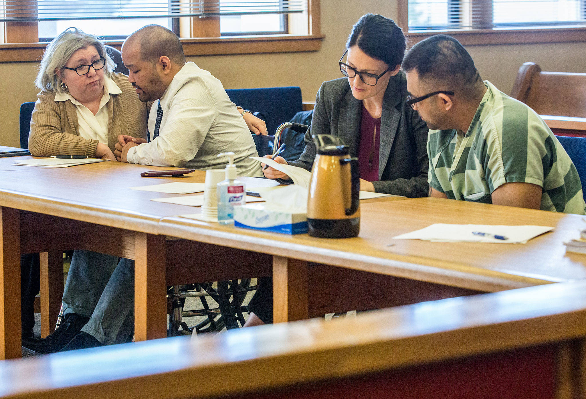 Youthy Chim (center left) and Saravouth Sun (right) chat with their lawyers before their sentencing Friday for the 2005 shooting of Jesse Williams. (Olivia Vanni / The Herald)