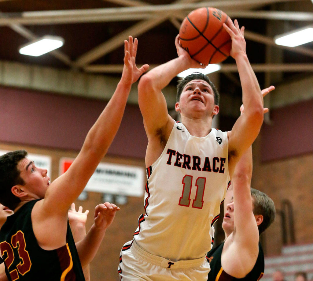 Mountlake Terrace’s Mason Christianson attempts a shot with Lakeside’s Jack Dickinson (left) defending during the 2018 Mountlake Terrace High School Holiday Tournament on Dec. 28, 2018. (Kevin Clark / The Herald)
