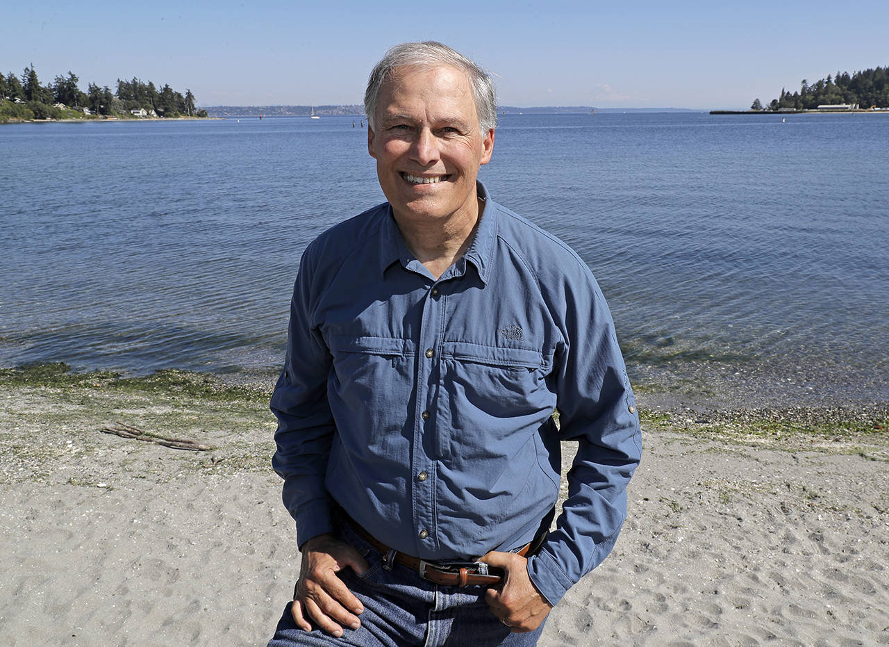 In this 2018 photo, Washington Gov. Jay Inslee poses for a photo on the beach near his home on Bainbridge Island. (AP Photo/Ted S. Warren)