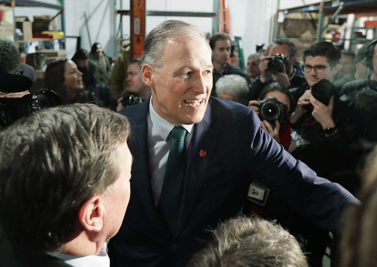 Washington Gov. Jay Inslee greets supporters Friday, after speaking at a campaign event at A&R Solar in Seattle. (AP Photo/Ted S. Warren)