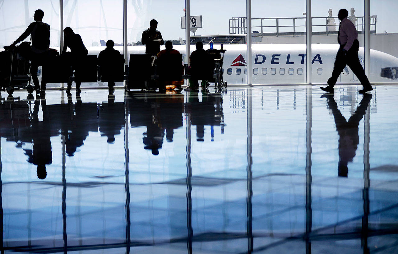 A Delta Air Lines jet sits at a gate at Hartsfield-Jackson Atlanta International Airport, in Atlanta, on Oct. 13, 2006.(AP Photo/David Goldman)