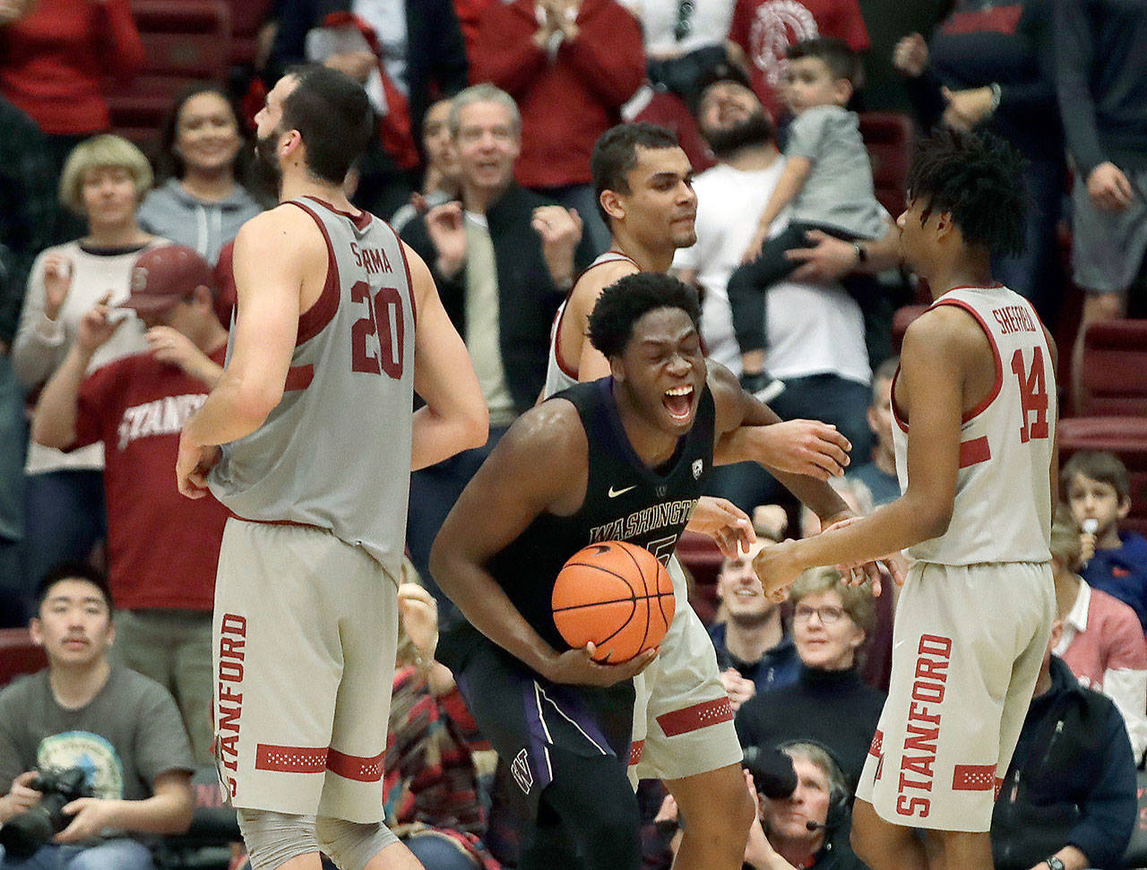 Washington’s Noah Dickerson (center with the ball) celebrates at the end of the Huskies’ 62-61 win over Stanford on Sunday. (AP Photo/Ben Margot)