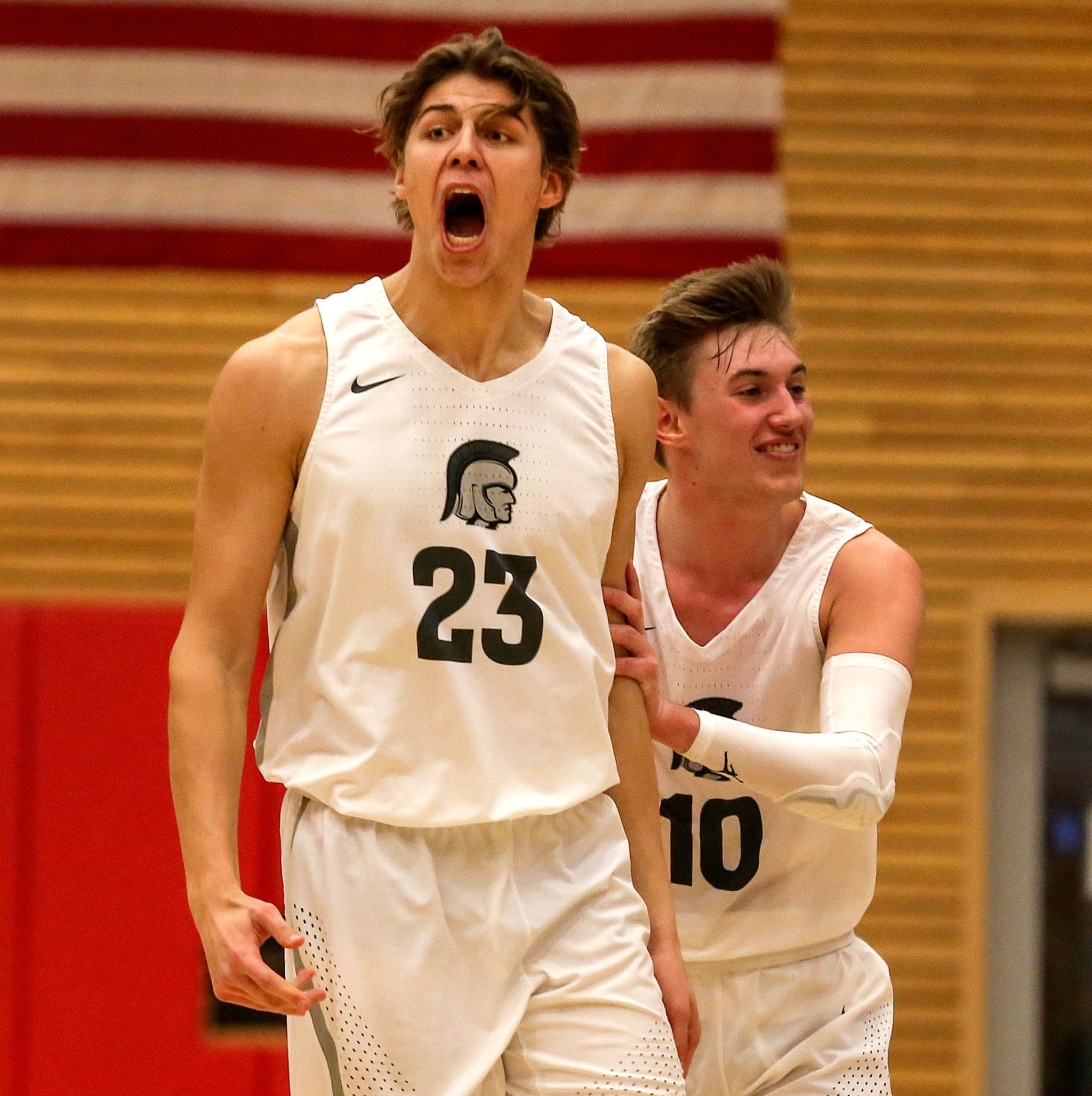 Everett Community College’s Magnus Jespersen (left) and Joe Crumley celebrate during a Feb. 20 NWAC men’s basketball game against Olympic in Everett. (Kevin Clark / The Herald)