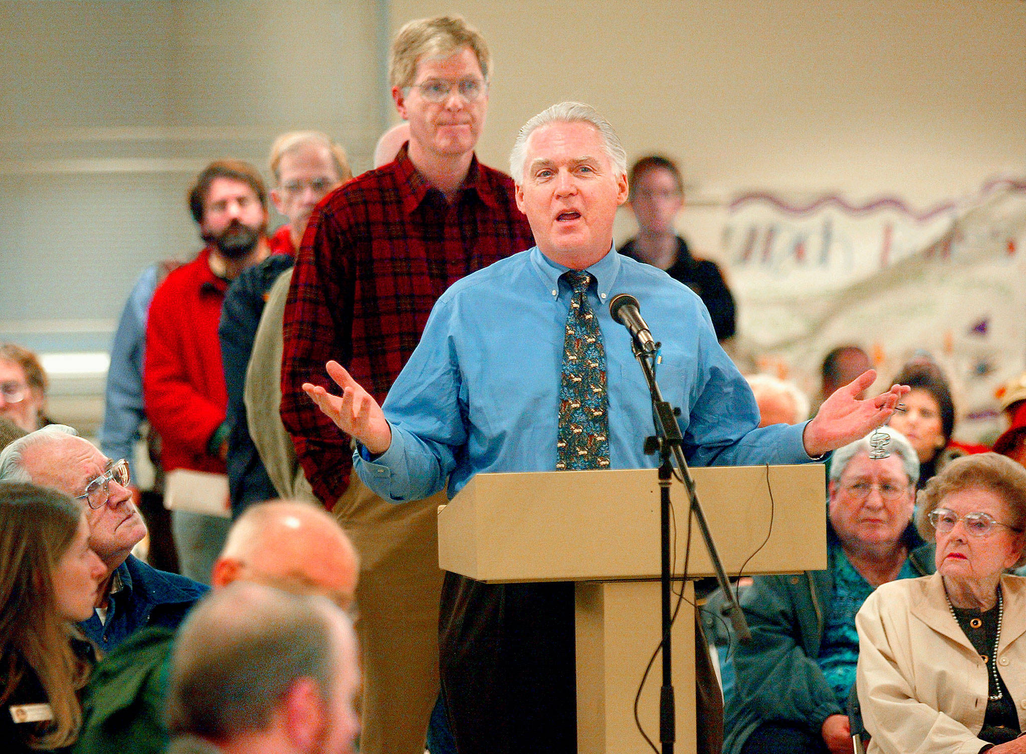Dr. Scott Casselman speaks out against airport expansion at Paine Field during a 2005 town hall meeting in Mukilteo. Now that commercial airline service has started, the Mukilteo resident hasn’t changed his views. (Dan Bates / The Herald)