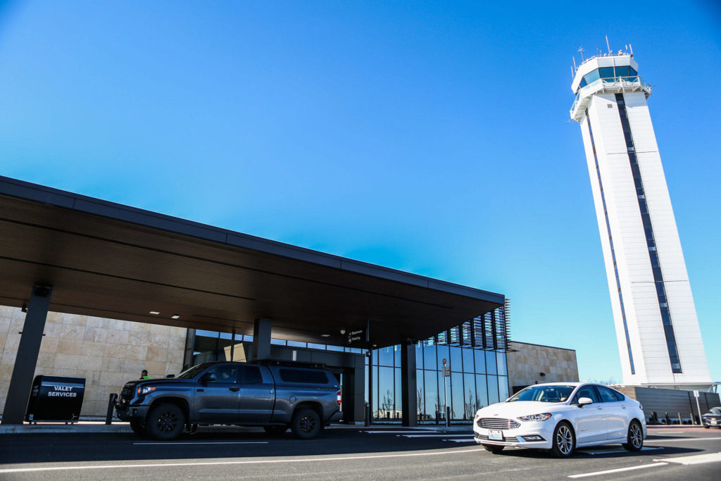 People arrive at the entrance to the terminal during the grand opening of the Paine Field Airport on Monday in Everett. (Olivia Vanni / The Herald)
