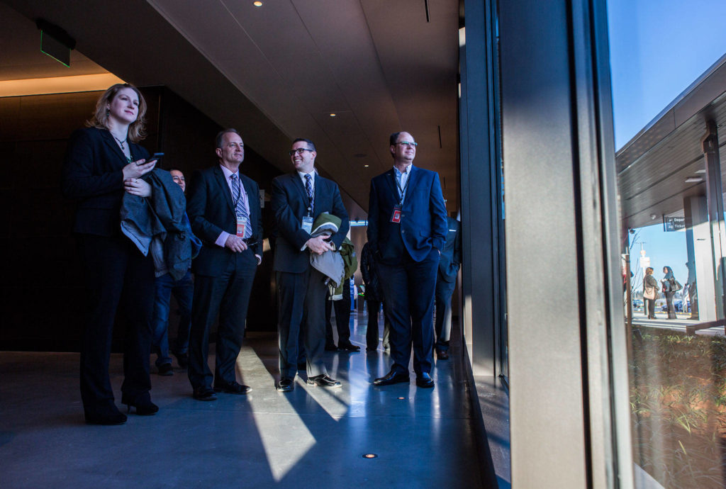 Paine Field Airport employees watch the statue unveiling during the grand opening of the Paine Field Airport on March 4 in Everett. (Olivia Vanni / The Herald)
