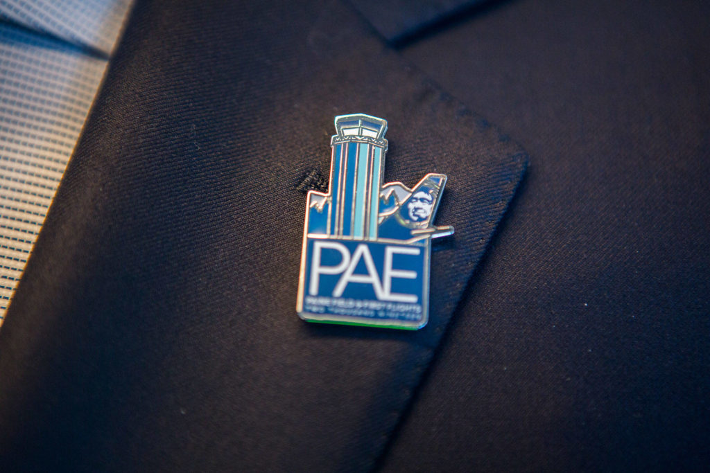 A speciality Paine Field pin is worn during the grand opening of the Paine Field Airport on March 4 in Everett. (Olivia Vanni / The Herald)
