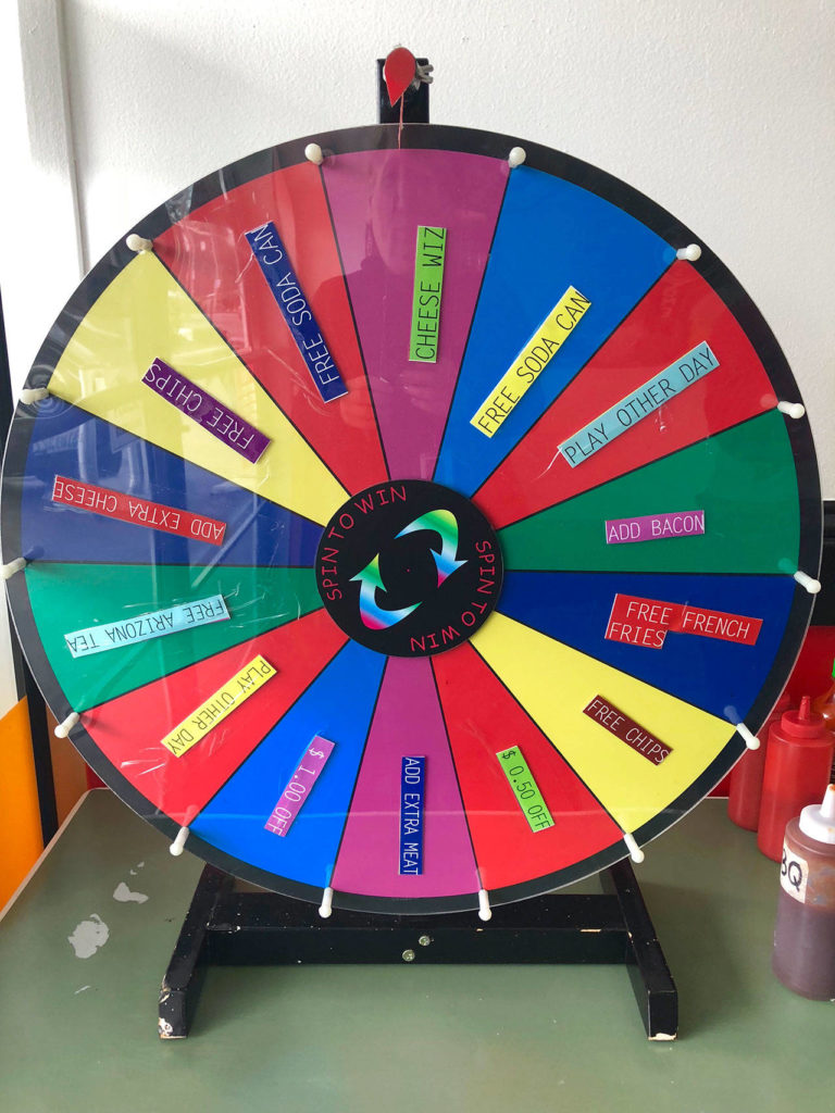 Customers can spin the prize wheel at Erwin’s Philly Cheese Steak for fun and freebies. (Andrea Brown / The Herald)
