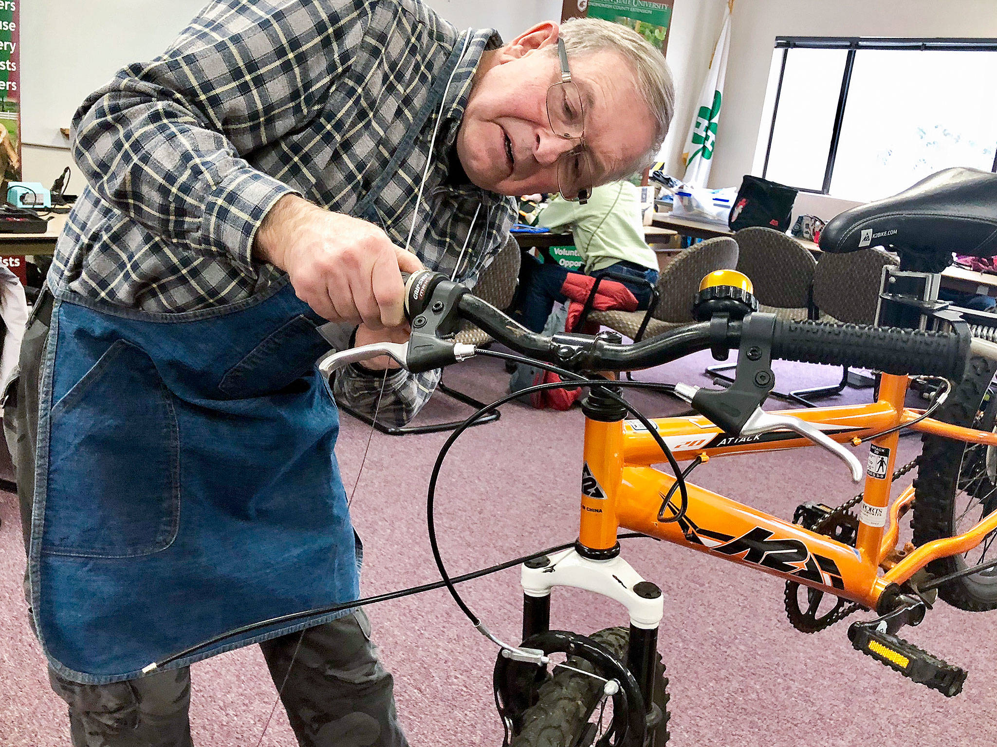 Dave Fox is among a dozen volunteers donating time at the Repair Cafe, a free monthly event where people bring things to be fixed. It is hosted by WSU Snohomish County Extension in McCollum Park. (Andrea Brown / The Herald)