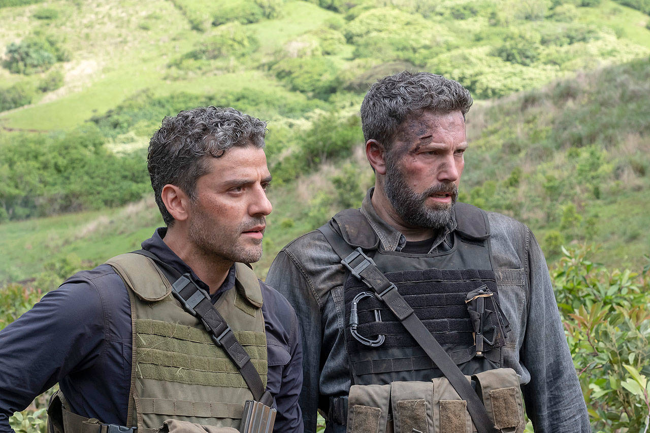 Oscar Isaac (left) and Ben Affleck play ex-Special Forces soldiers after a drug lord’s loot in “Triple Frontier.” (Netflix)
