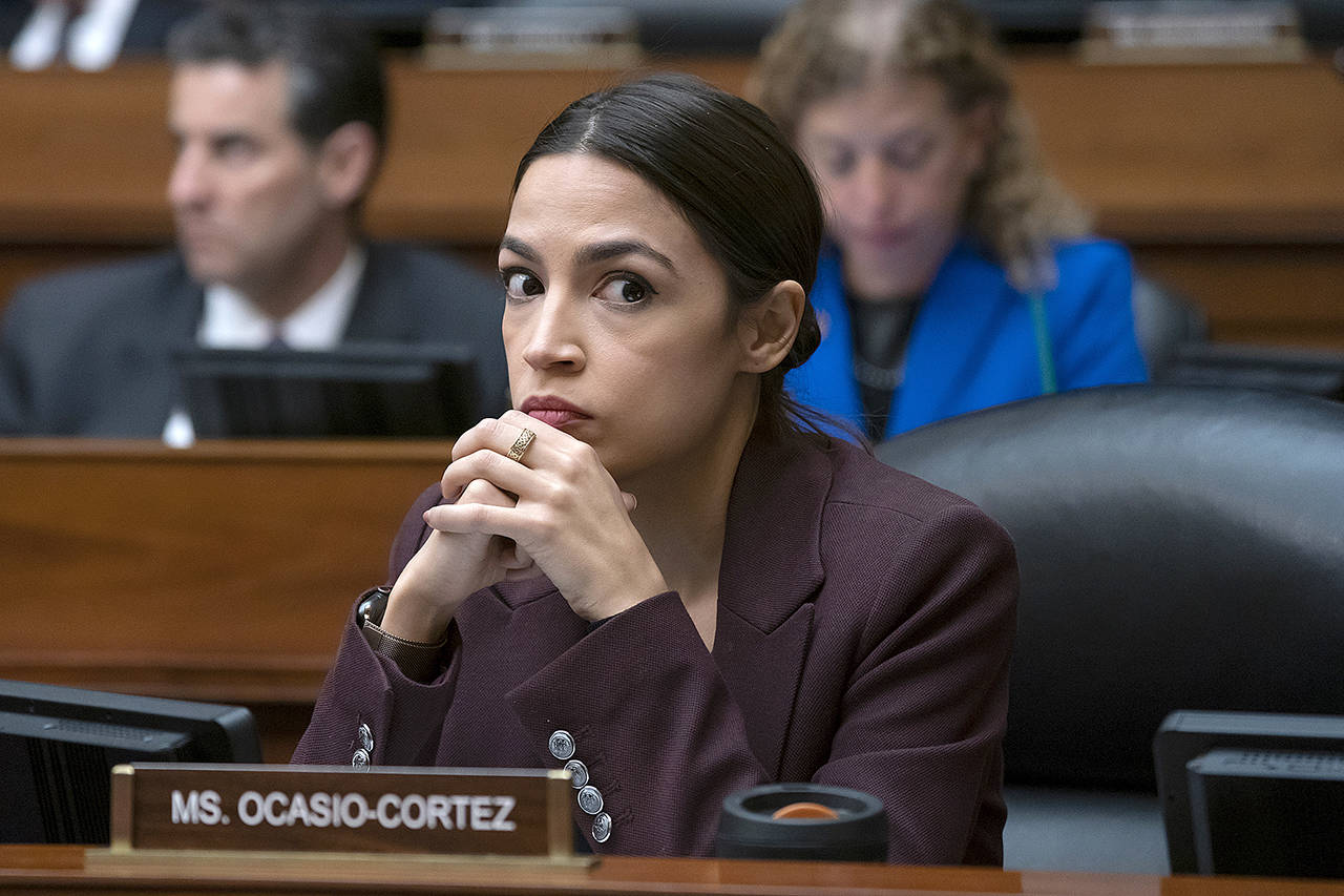 Rep. Alexandria Ocasio-Cortez, D-N.Y., listens to questioning of Michael Cohen, President Donald Trump’s former personal lawyer, at the House Oversight and Reform Committee, on Capitol Hill in Washington on Feb. 27. (AP Photo/J. Scott Applewhite)