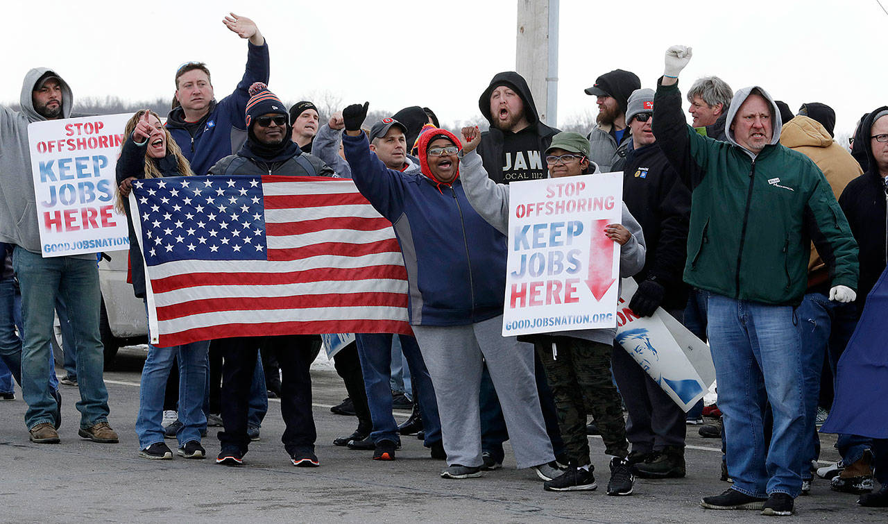 General Motors employees gather outside the plant for a protest, Wednesday in Lordstown, Ohio. General Motors’ sprawling Lordstown assembly plant near Youngstown is ending production of the Chevrolet Cruze sedan, ending for now more than 50 years of auto manufacturing at the site. (AP Photo/Tony Dejak)