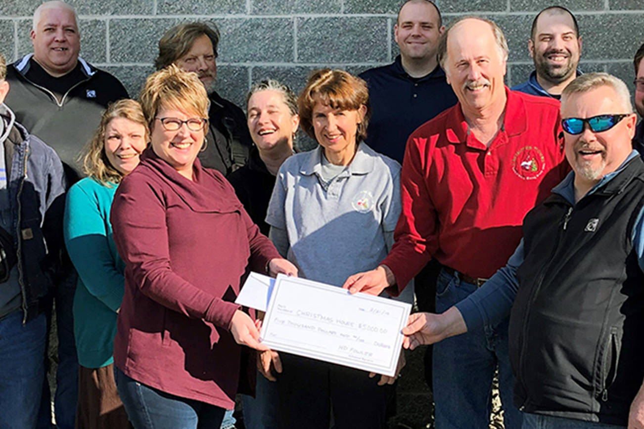 Christmas House president Gregg Milne and treasurer Rosemary Randall receive a $5,000 check from John Cosner, Jan Brooks and fellow H.D. Fowler Co. employees. (Contributed photo)