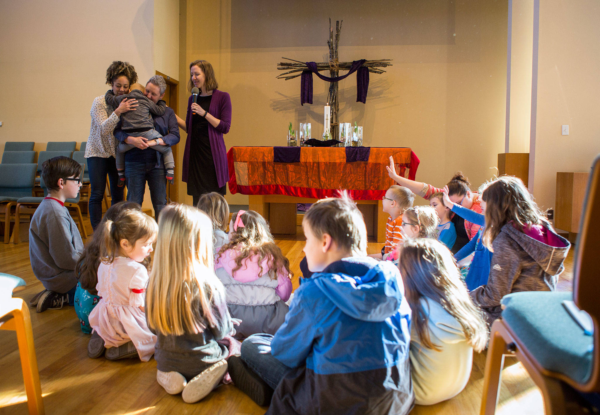 Pastor Jenny Smith asks her congregation to help send off Monica Reed, Heather Reed and their son Bryce Reed, 3, before their move to Orlando, Florida, during Sunday service at Marysville United Methodist Church. (Olivia Vanni / The Herald)