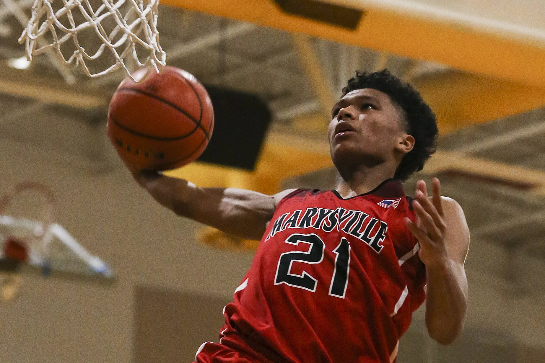 Marysville Pilchuck’s RaeQuan Battle winds up for a dunk during his school-record 43-point performance in a win over Edmonds-Woodway this past December. The University of Washington-bound star averaged 22 points and nine rebounds per game while leading the Tomahawks to a program-best fourth-place state trophy. (Kevin Clark / The Herald)