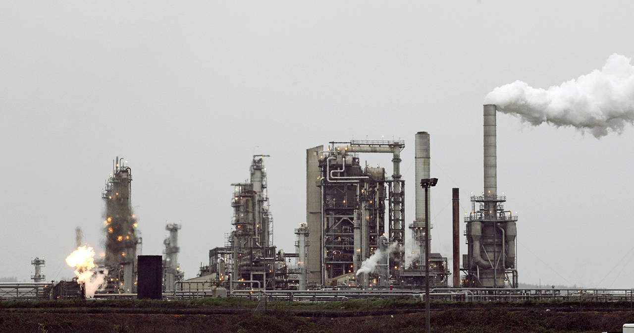 A gas flame, part of normal plant operations, flares at a refinery in April 2010, now owned by Andeavor, formerly Tesoro Corp., in Anacortes. (Ted S. Warren/Associated Press file photo)