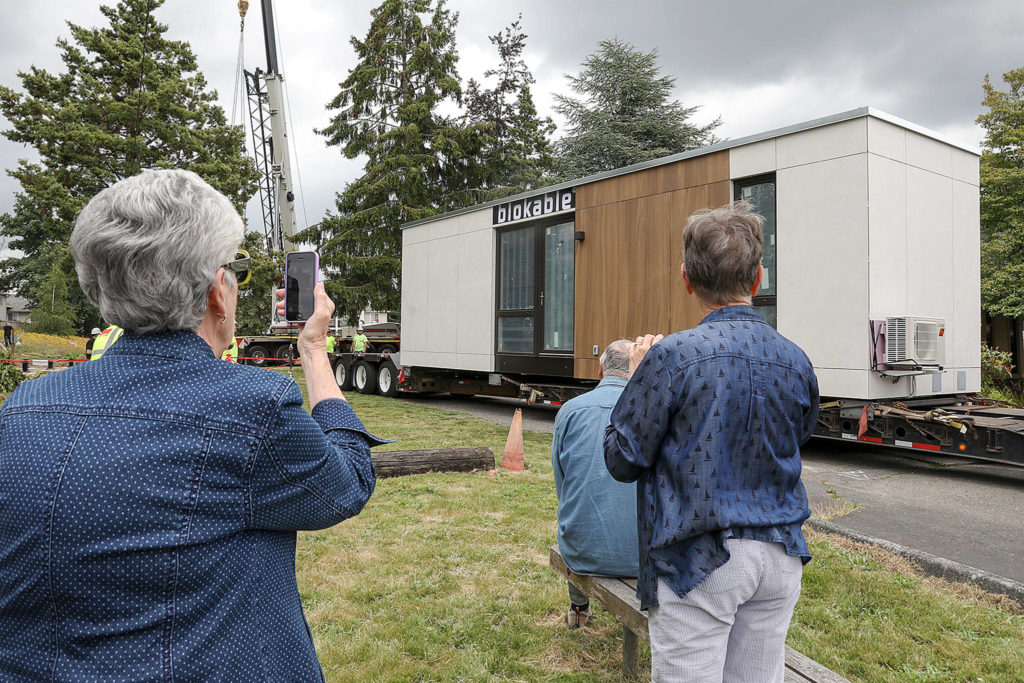 Lizz Giordano / Herald File
Members of Edmonds Lutheran Church congregation gathered last June as the first Blokable unit is placed on church grounds. The project will bring low-income housing to the city. The church, which hosts a community dinner each week, is one of a handful of faith-based organizations in Edmonds that provides almost all of the supportive services for homeless Edmonds residents.
