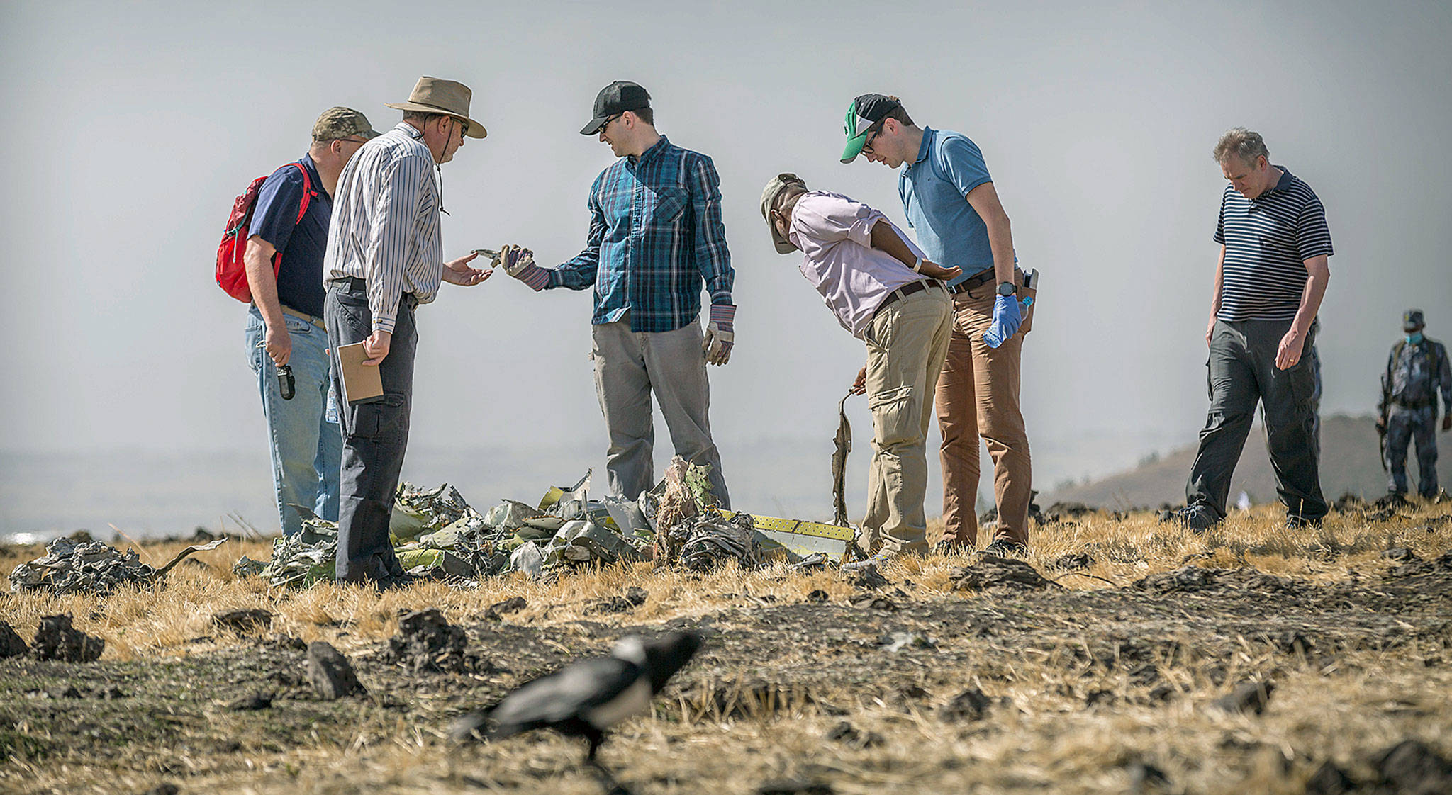 Investigators on Tuesday examine wreckage at the scene of an Ethiopian Airlines Boeing 737 MAX 8 crash near Addis Ababa, Ethiopia. (AP Photo/Mulugeta Ayene)