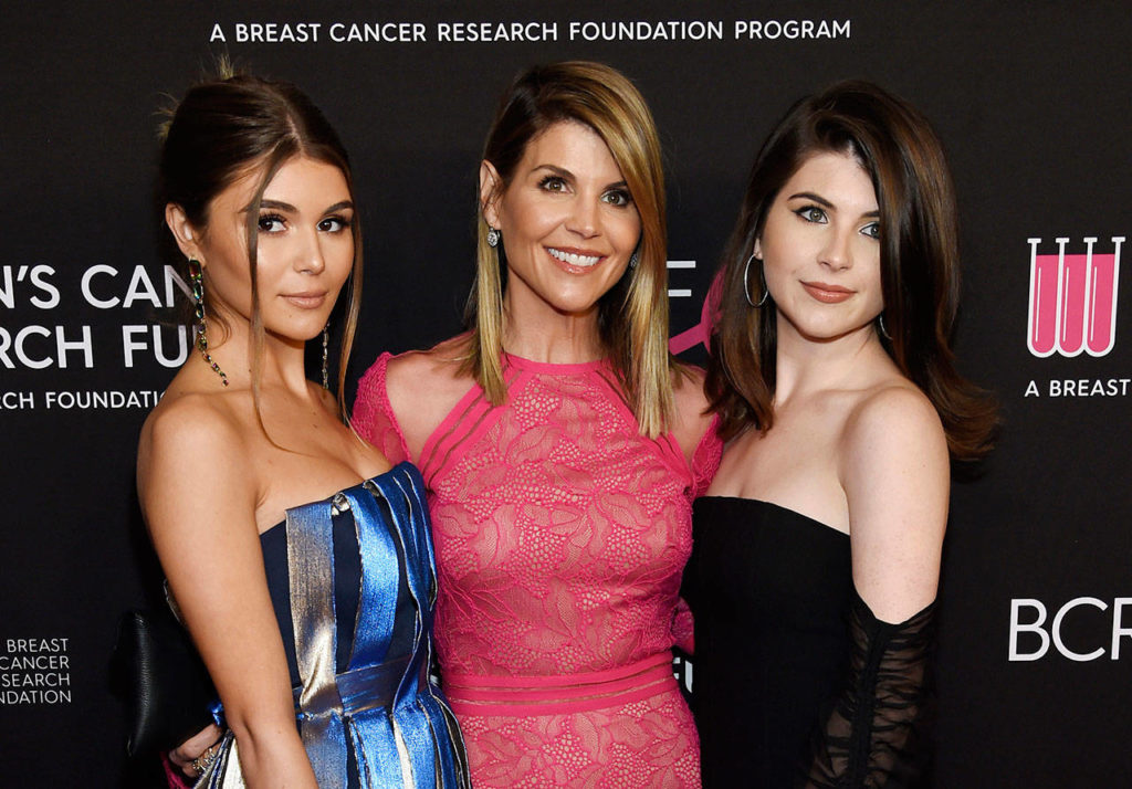 In this Feb. 28 photo, actress Lori Loughlin (center) poses with daughters Olivia Jade Giannulli (left) and Isabella Rose Giannulli at the 2019 “An Unforgettable Evening” in Beverly Hills, California. Loughlin and her husband, Mossimo Giannulli, were charged along with nearly 50 other people Tuesday in a scheme in which wealthy parents bribed college coaches and other insiders to get their children into some of the most elite schools in the country, federal prosecutors said. (Photo by Chris Pizzello/Invision/AP, File)
