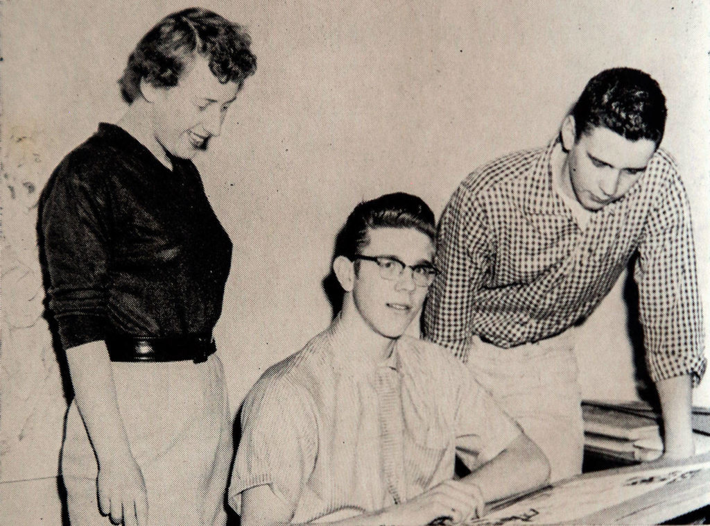 Artist Chuck Close (center) was among Ruth May Scougate’s students who worked on the yearbook at Everett High School. A photo from the 1957 Nesika shows Close and classmates Barbara Wick and Chuck Thorpe looking at his work. (Dan Bates / The Herald)
