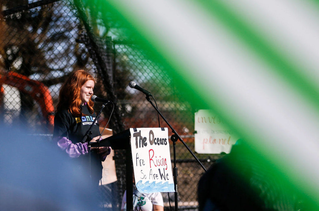Grace Lambert, a student organizer from Jackson High School, speaks to the crowd during the Youth Climate Strike at Cal Anderson Park in Seattle on Friday. (Olivia Vanni / The Herald)
