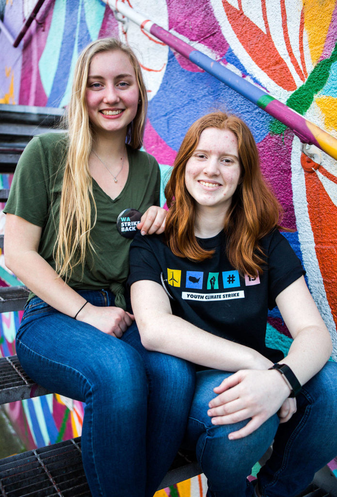 Cousins Ashley Lambert (left) and Grace Lambert (right), from Jackson High School, spearheaded the organization and planning for the Youth Climate Strike at Cal Anderson Park in Seattle on Friday. (Olivia Vanni / The Herald)
