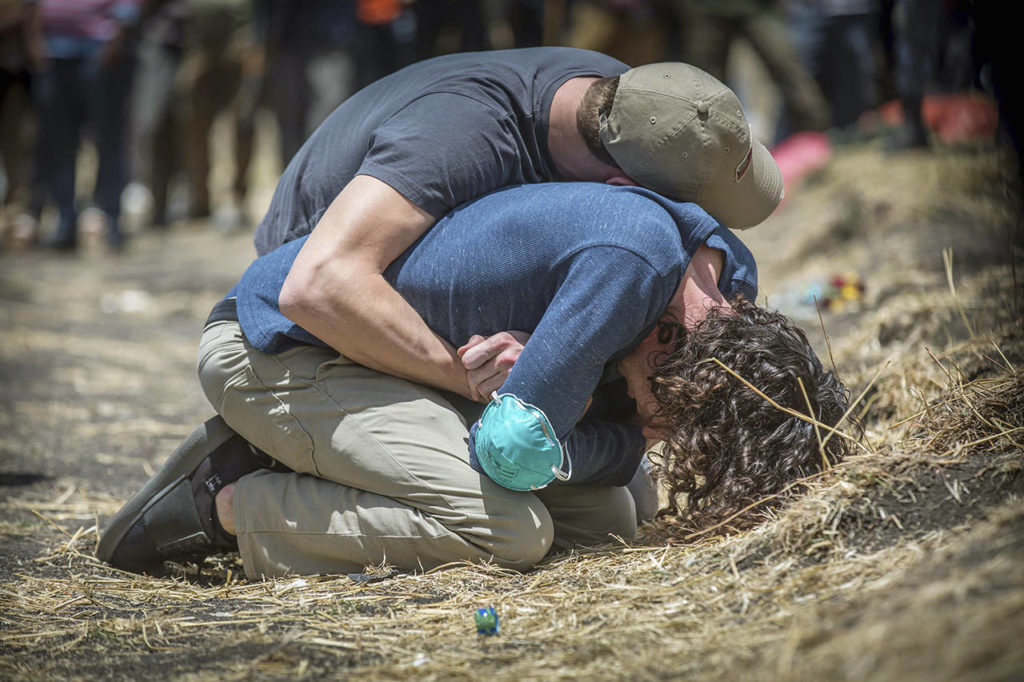 Mulugeta Ayene / associated press 
Relatives weep Wednesday at the scene where the Ethiopian Airlines Boeing 737 Max 8 crashed Sunday, killing all 157 on board, near Bishoftu, Ethiopia, on Wednesday.
