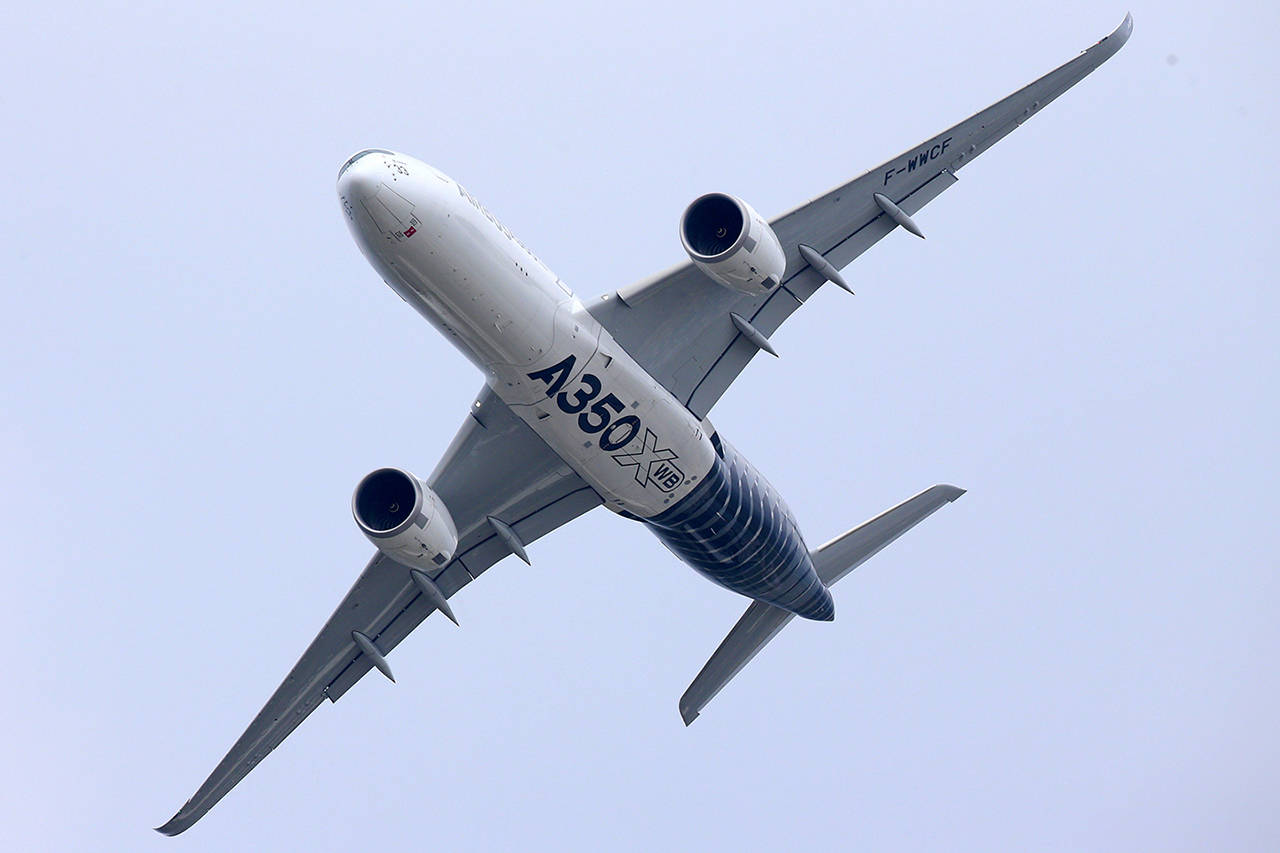 An Airbus SAS A350 XWB aircraft performs a flying display on the opening day of the 51st International Paris Air Show in Paris on June 15, 2015. French President Emmanuel Macron will discuss a major Airbus order during his Chinese counterpart Xi Jinping’s state visit to France later this month. (Jasper Juinen/Bloomberg, file)