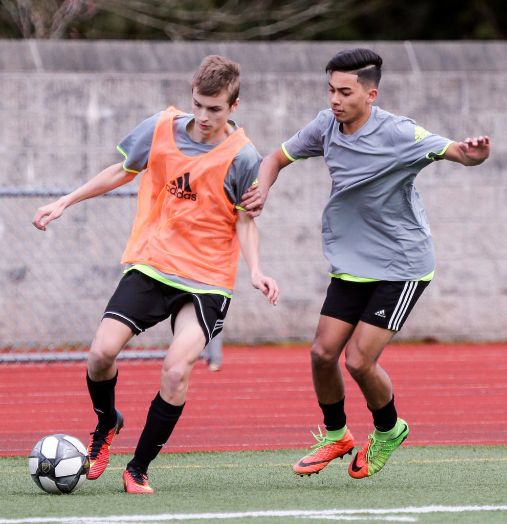 Lake Stevens’ Aiden Crook (left) controls the ball with Jaydon Digos defending Thursday afternoon at Caviler Mid High School in Lake Stevens on March 13, 2019. (Kevin Clark / The Herald)
