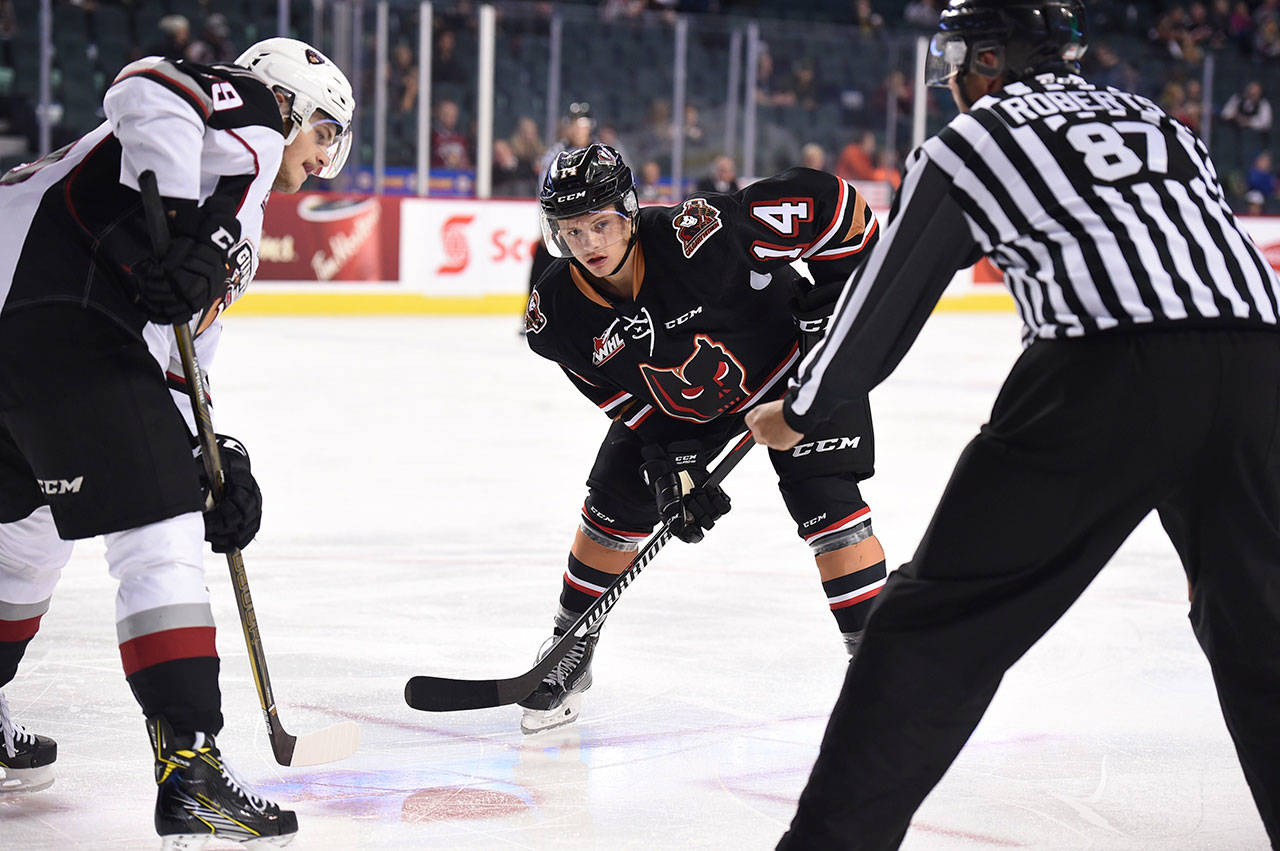 Lucas Cullen (4) takes part in a faceoff during his time with the Calgary Hitmen. (Courtesy of Silvertips)