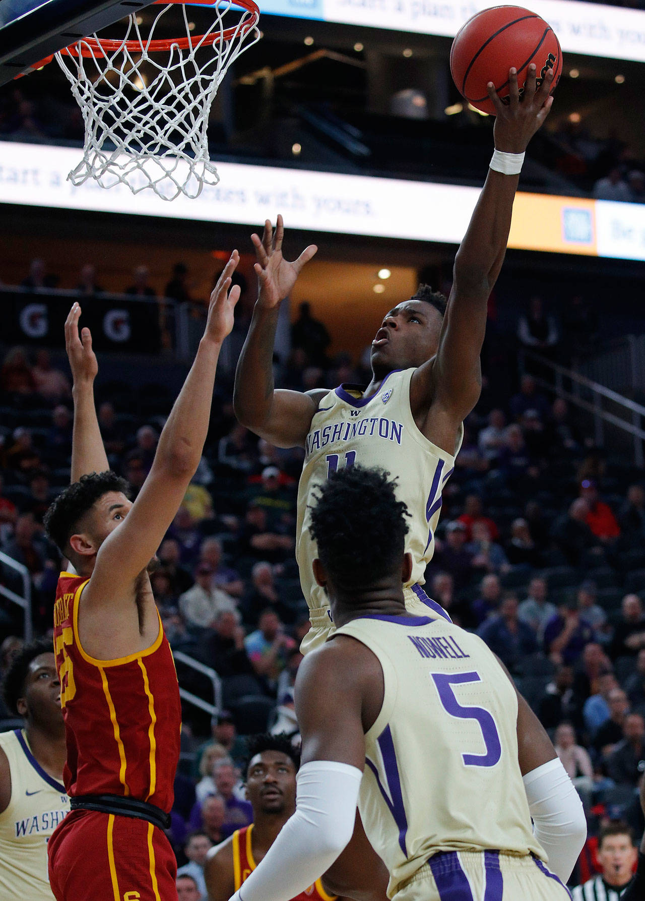 Washington’s Nahziah Carter shoots over Southern California’s Bennie Boatwright during the first half of Sunday’s Pac-12 men’s tournament game in Las Vegas. (AP Photo/John Locher)