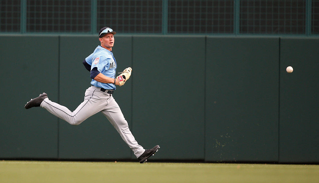 The Mariners’ Jarred Kelenic chases a ball during a spring game against the Dodgers on March 9, 2019, in Phoenix. (AP Photo/Sue Ogrocki)